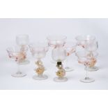 A set of six Venetian glass champagne coupes decorated gilt trails and four glasses with dolphin