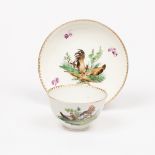 A Hague tea bowl and saucer, circa 1780, decorated hens and puce flowers,