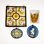 A square stained glass leaded panel with central bulls' eye and surround of four floral panels,