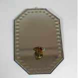 An Art Deco wall sconce, the mirrored back with convex dot borders,