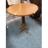 A circular mahogany table on a Victorian cast iron support,