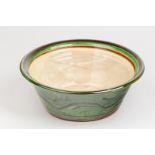 Penny Simpson (born 1949), a stoneware fruit bowl with brushwork applied green glaze,