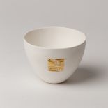 Angela Mellor (Contemporary), a white bone china paperclay sake cup with textured gold square motif,