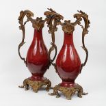 A pair of 19th Century gilt metal mounted vases, perhaps red hyalith glass,