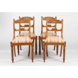 Four Regency mahogany dining chairs fitted loose trap seats,