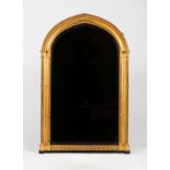 A Victorian Gothic gilded wall mirror with arched top and cluster columns to the side,