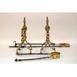 A pair of brass andirons and a set of steel brass handled fire irons