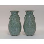 A pair of Chinese celadon crackle ware vases each with two moulded handles,