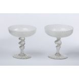 A pair of 19th Century Venetian glass coupes with white reticello bowls on spiral ribbed stems,