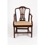 A mahogany armchair with pierced upright splat and swept back arms,