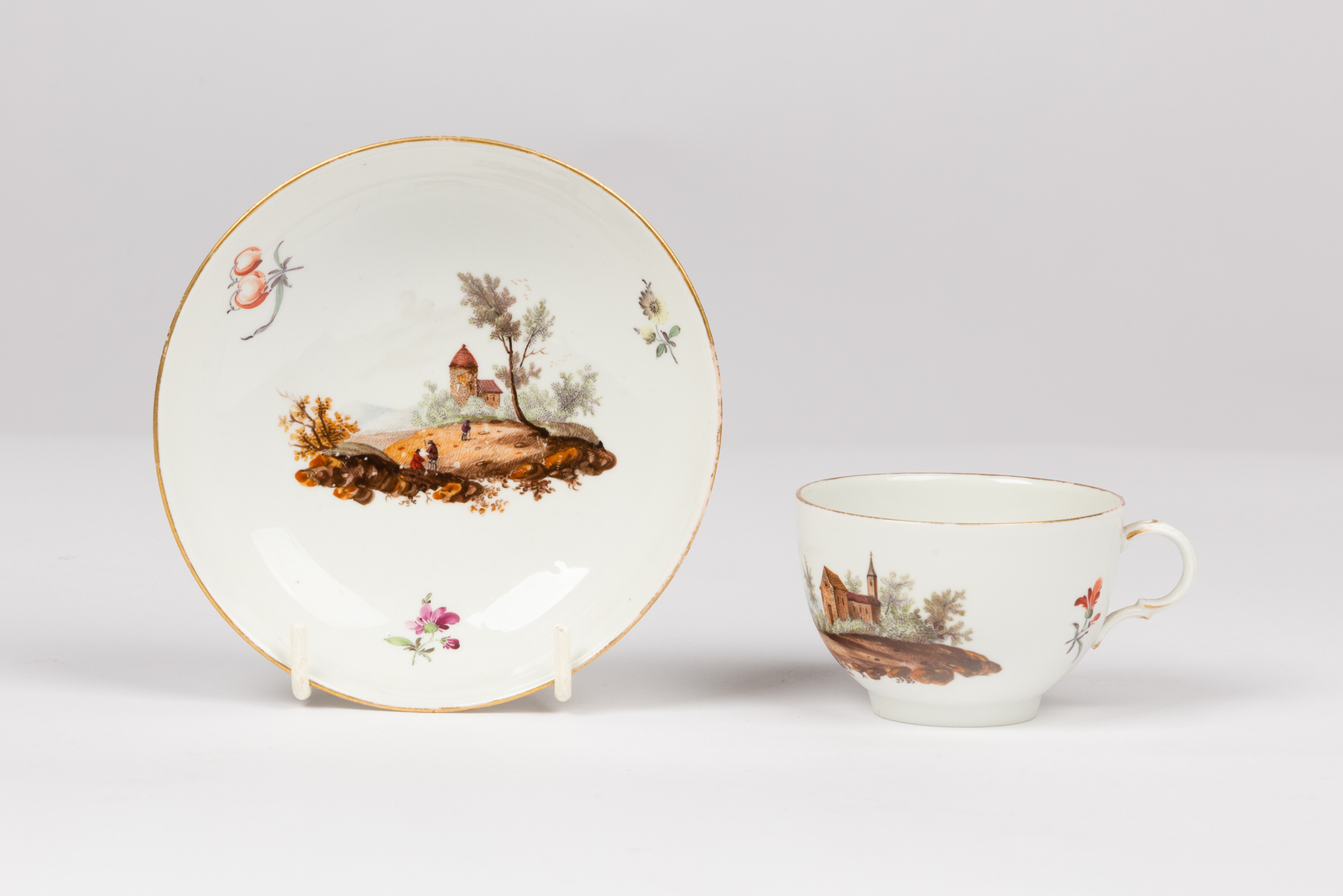 A Furstenberg teacup and saucer, late 18th Century, painted landscapes and scattered sprigs, - Image 2 of 7