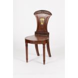A William IV mahogany hall chair with carved portcullis cresting to the back,
