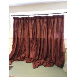 A pair of dark red silk curtains with pelmet and tie backs,