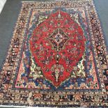 A Qashqai carpet with central red ground floral medallion within a multi figured border,