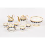 A Paris porcelain part coffee service, circa 1810, decorated matt blue acanthus and gilt,