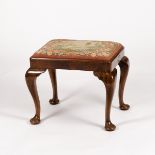 A walnut dressing stool of Queen Anne design,
