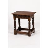 A small oak joint type stool, on carved baluster legs and square stretchers,
