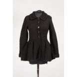 Redheart, England, a black knitted wool peplum jacket with revere collar and button front fastening,