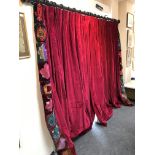 A pair of crimson velvet curtains with patchwork borders and tie backs by Julia Trevelyan Oman,