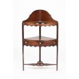 A George III mahogany corner washstand fitted a glass bowl to the top,