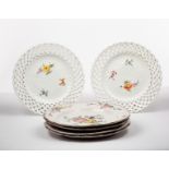 A pair of Meissen plates, late 19th Century, with pierced lattice rims, painted scattered sprigs,