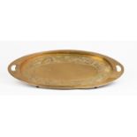 A brass Arts & Crafts oval tray with pierced handles, embossed border of dragons, 67.