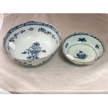 An English blue and white Delft bowl painted an arrangement of flowers,