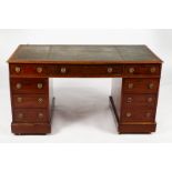 A mahogany pedestal desk fitted a surround of nine drawers,