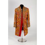 An Indian coat in claret paisley silk profuse decorated with gold foliate embroidery,