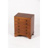 A mahogany apprentice chest with inlaid surround,