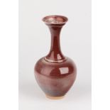 Bridget Drakeford (born 1946), a porcelain bottle vase with slender neck, sang de boeuf glaze,