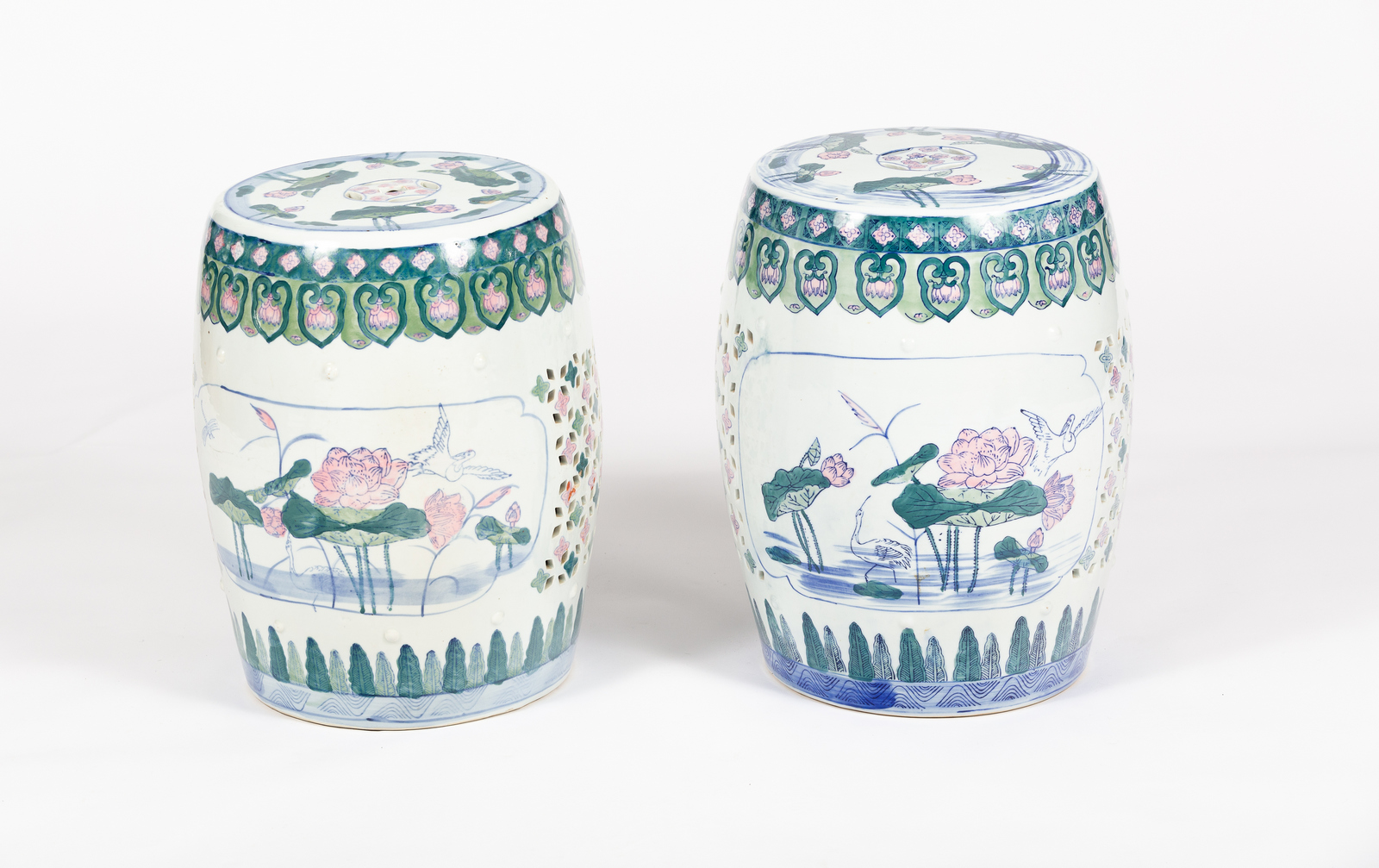 A pair of Chinese porcelain barrel-shaped garden seats with pierced tops,