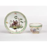 A Meissen green mosaic pattern teacup and saucer, 19th Century, painted with soldiers in landscapes,