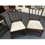 A pair of fruitwood single chairs with upright splats and loose trap seats,