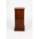 A late Victorian mahogany pedestal cupboard with stepped top and base,