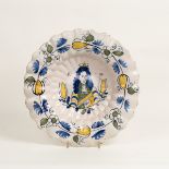 A Dutch Delft Royal portrait dish, of lobed form, painted in blue,