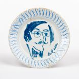 A plate decorated a portrait of Sir Roy Strong by Yaacov Agam with border of scrolls, 16.