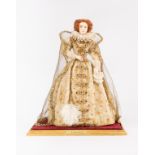 A costume figure of Elizabeth I wearing a pearl lined cape, ruff and jewelled buttons,