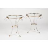 A pair of modernist perspex and glass tables, the circular tops on outswept tripod support,