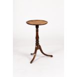 A small circular table with a leather lined top, on turned column and tripod support,