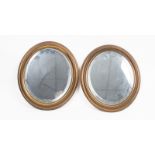 Two small brass oval mirrors with bevelled glass,