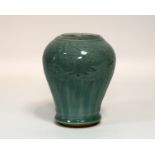 A 17th Century Chinese celadon vase with incised floral decoration,