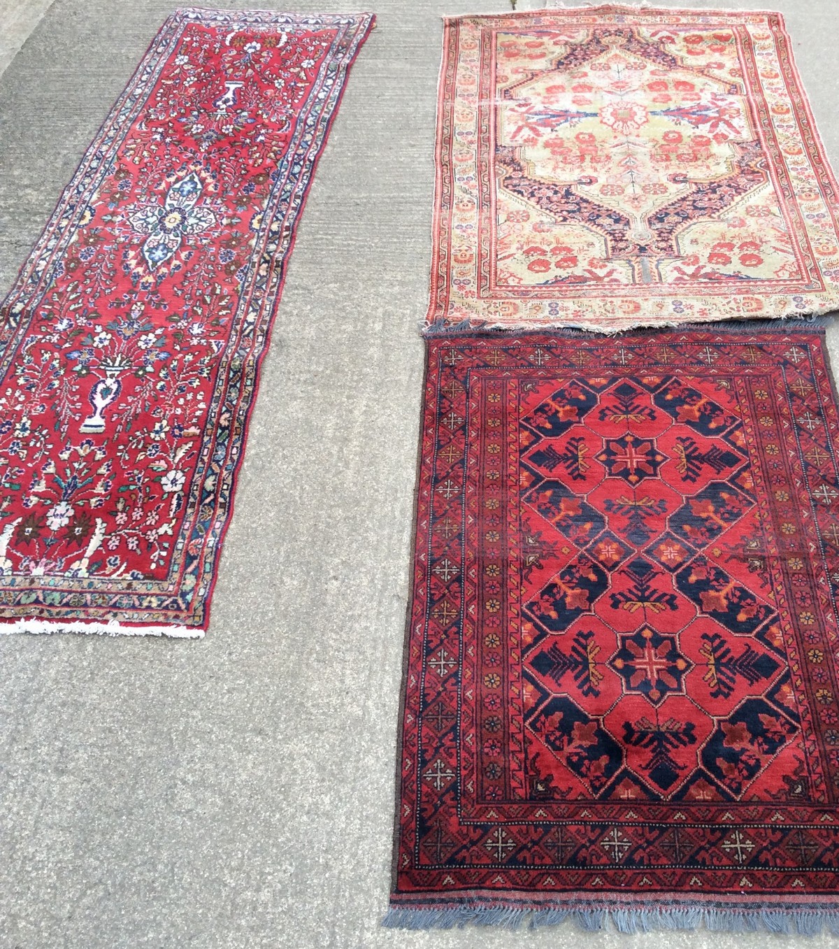 A Pakistan red ground rug with twin central medallion, 150cm x 103cm,