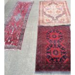 A Pakistan red ground rug with twin central medallion, 150cm x 103cm,