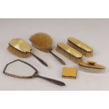 A silver and yellow enamel dressing table set, Birmingham 1926, comprising hand mirror, pair of