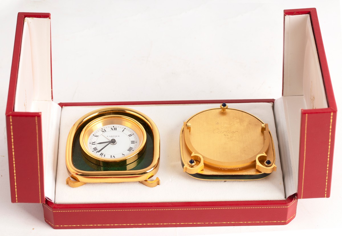 A Cartier alarm clock, 8cm high and a picture frame en-suite,