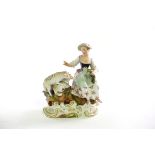 A Meissen group of a girl and sheep, incised 2934, 14.
