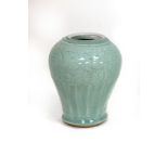 A 17th Century Chinese celadon vase with incised floral decoration,