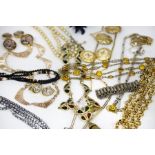 A quantity of costume jewellery including necklaces, ear clips, faux pearls,