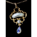 An Art Nouveau 15ct gold pendant of openwork form set with mother-of-pearl and an opal drop on a